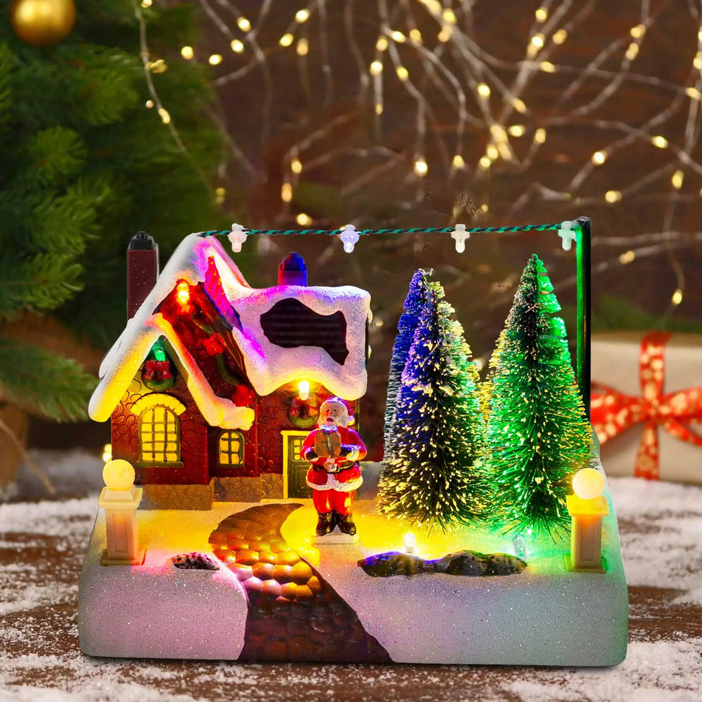 Pueblo navideño iluminado con Papá Noel y árboles